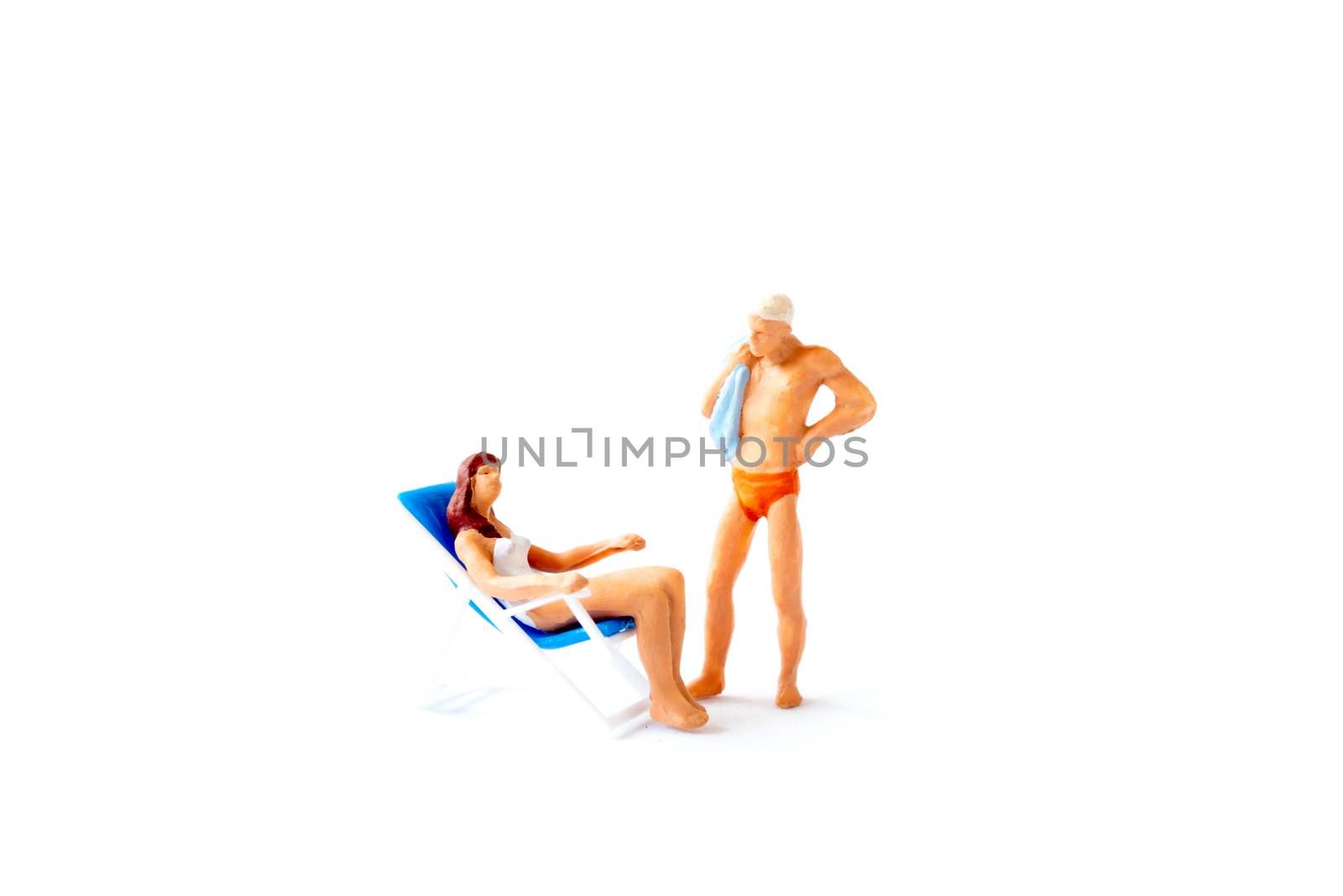 Miniature people sunbathing on deck chairs on white background , Summer time concept