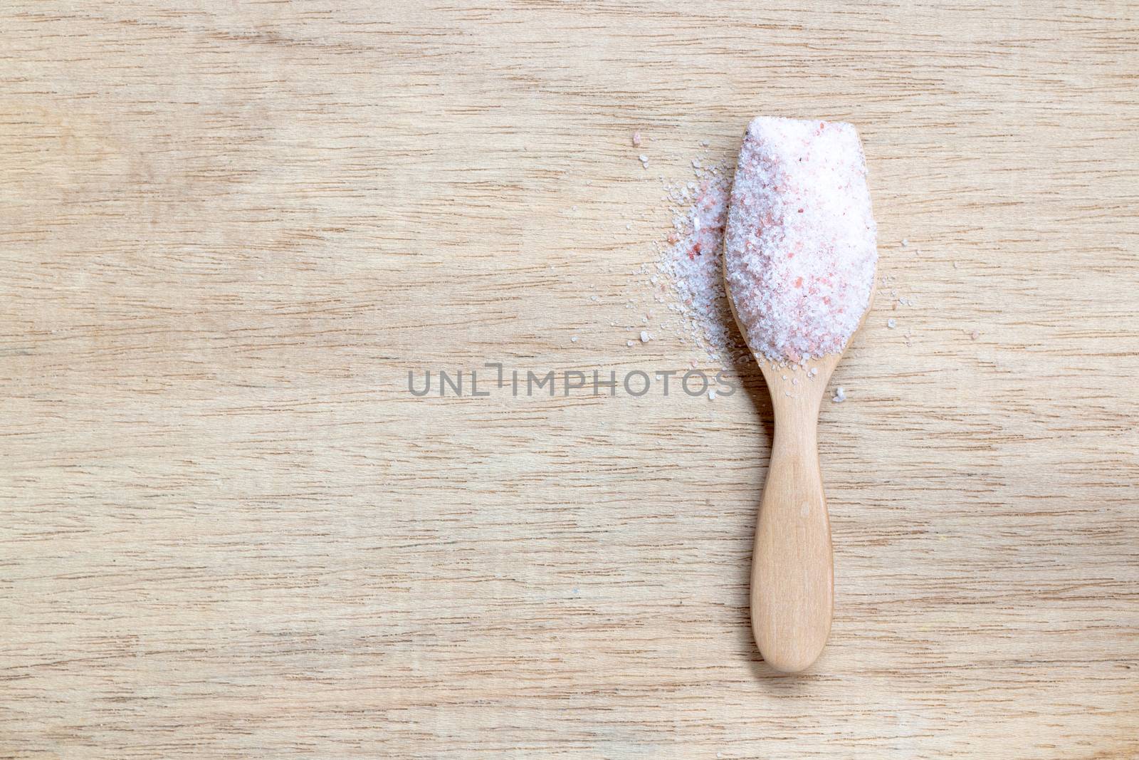 Pink salt , Himalayan salt on wooden background