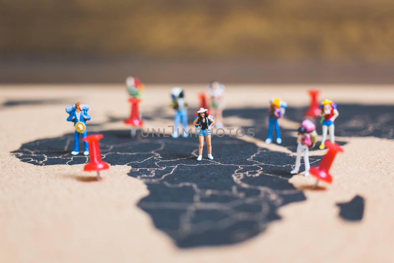 Miniature people backpacker walking on world map, Tourism and travel concept