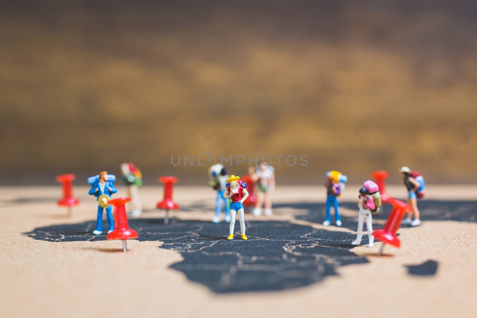 Miniature people backpacker walking on world map, Tourism and travel concept