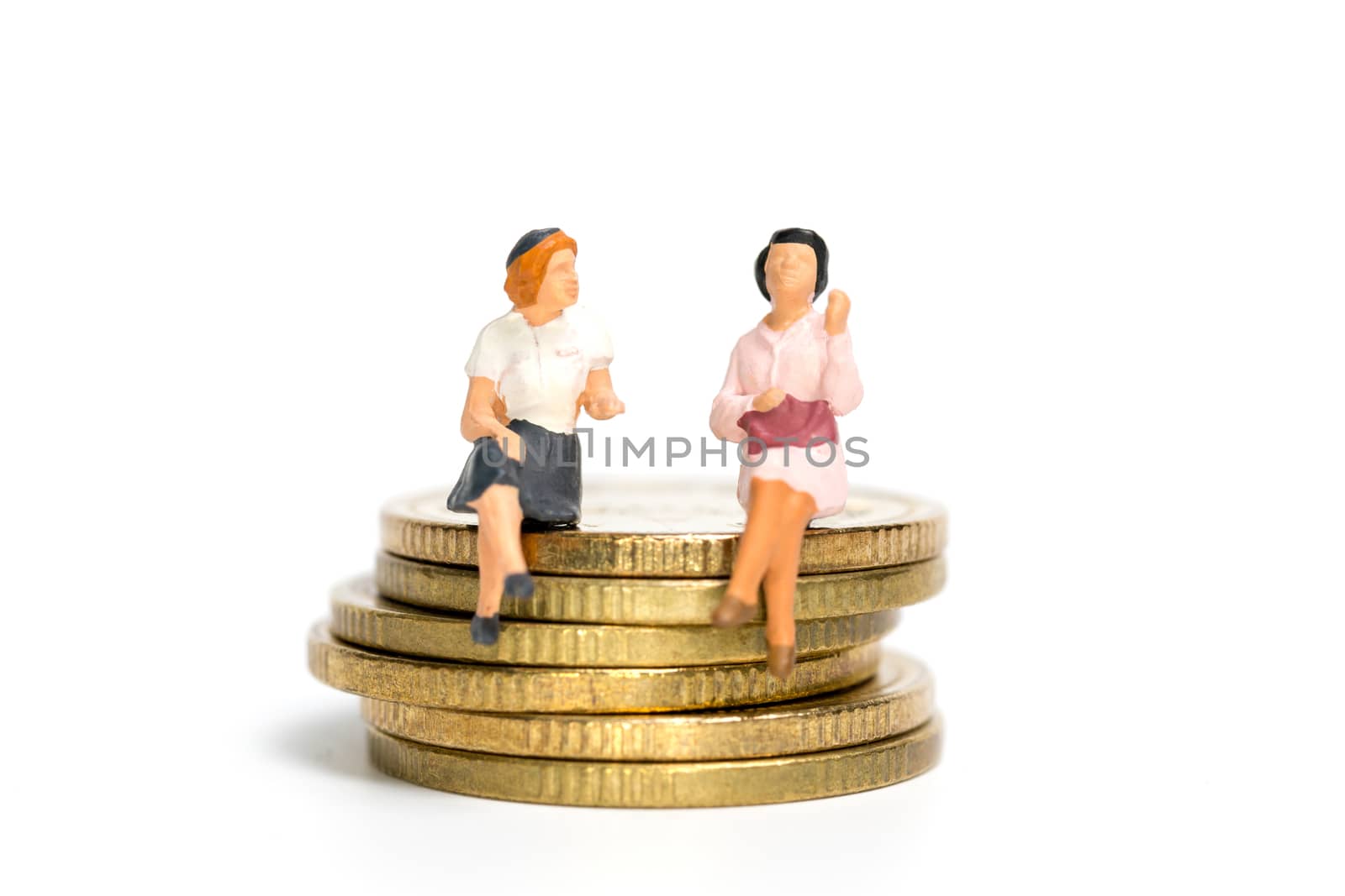 Miniature people: Businessman sitting on stack of coin , Money and financial concepts.