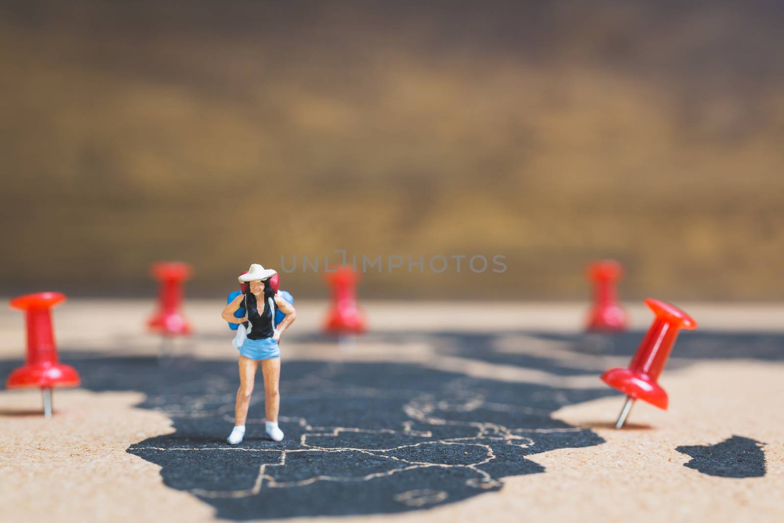 Miniature people backpacker walking on world map, Tourism and travel concept