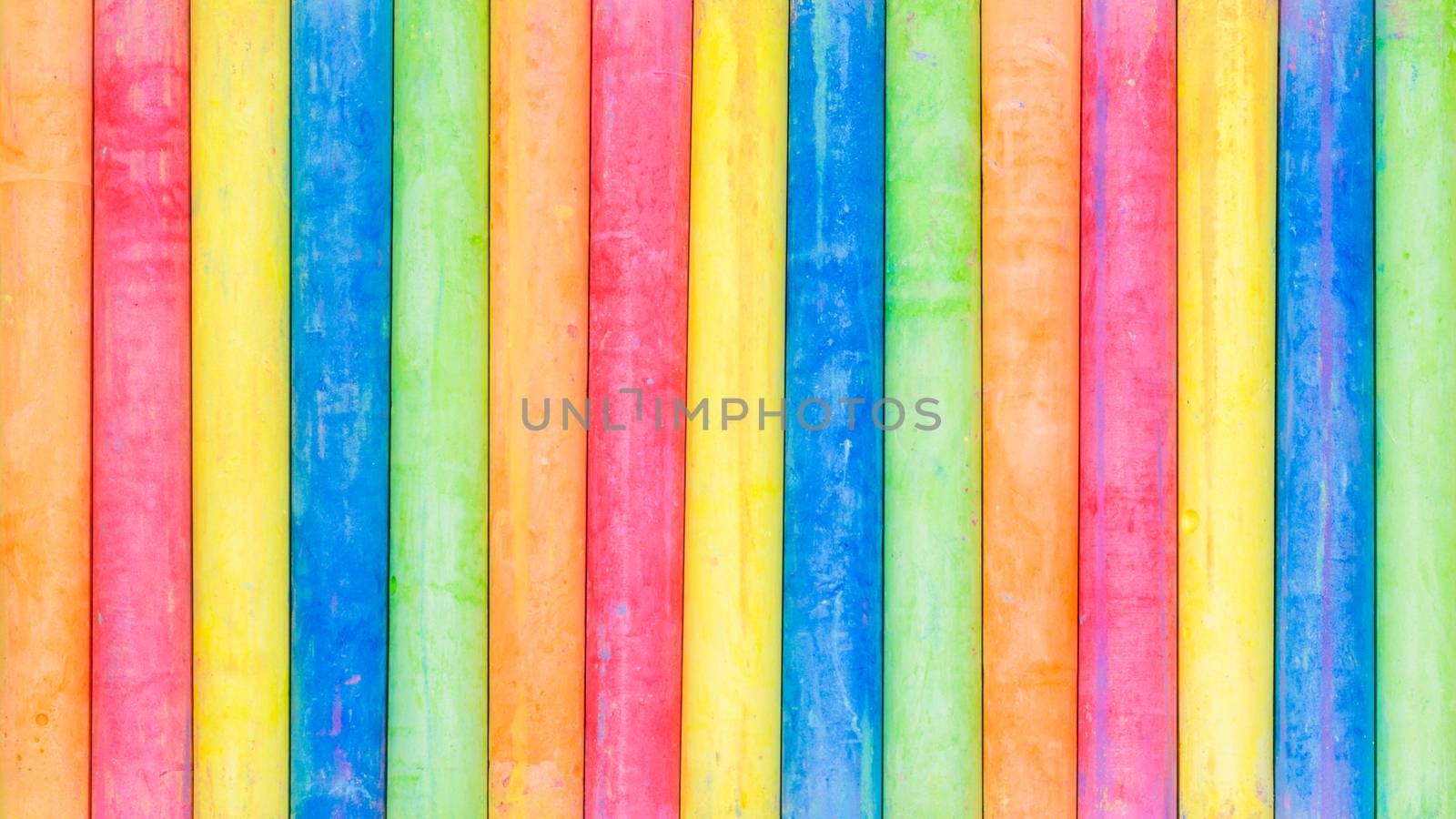Row of rainbow colored chalk background