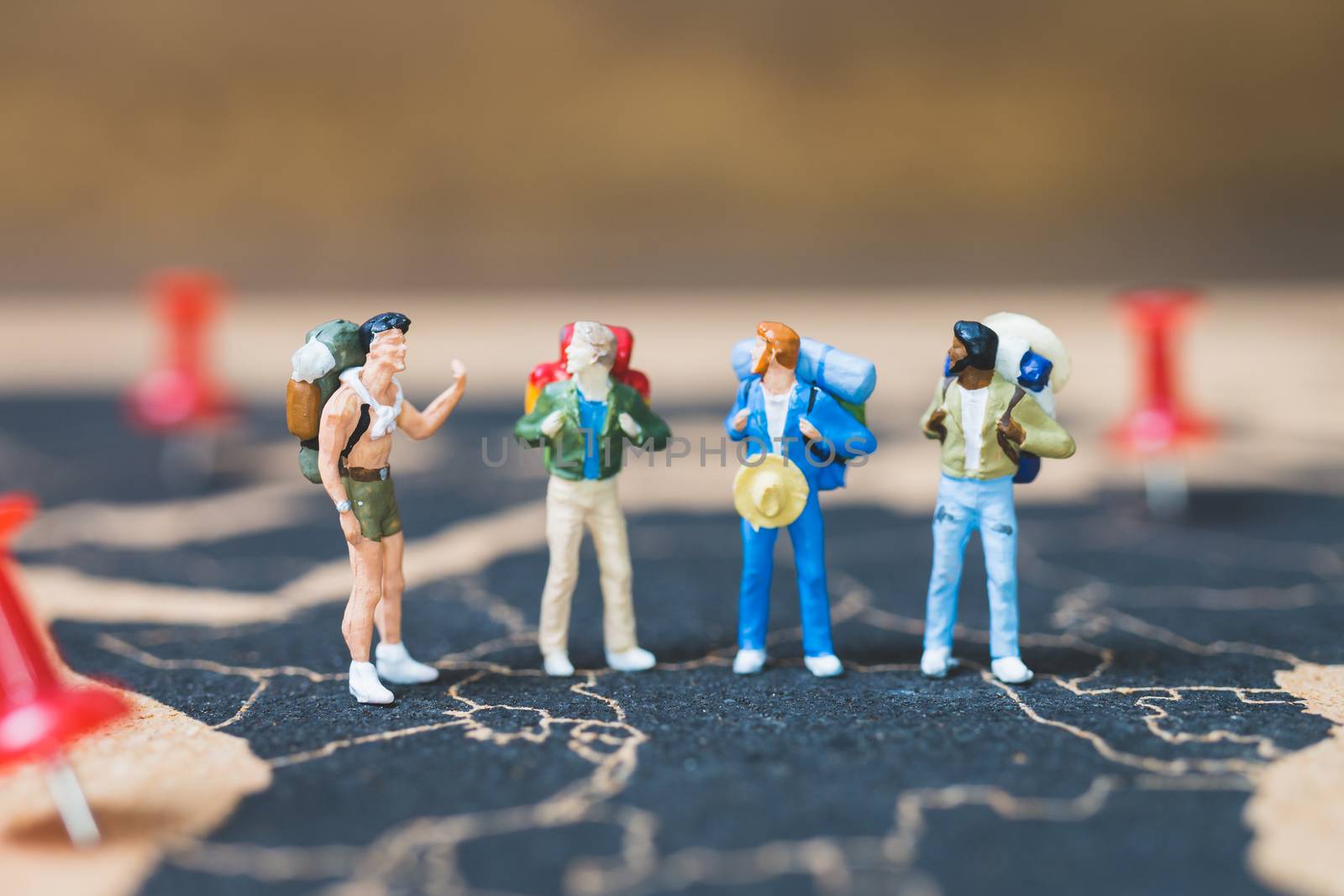Miniature people backpacker walking on world map, Tourism and travel concept