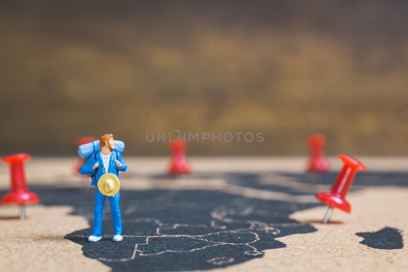 Miniature people backpacker walking on world map, Tourism and travel concept