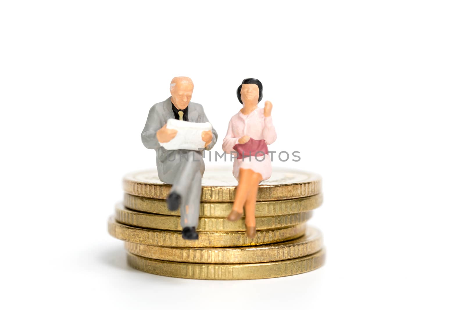 Miniature people: Businessman sitting on stack of coin , Money and financial concepts.