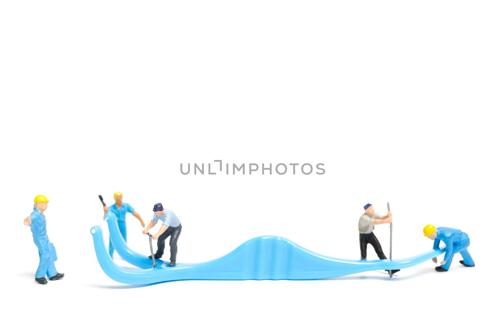 Miniature people : The team work on Dental floss isolate on white background , Dental clinic concept