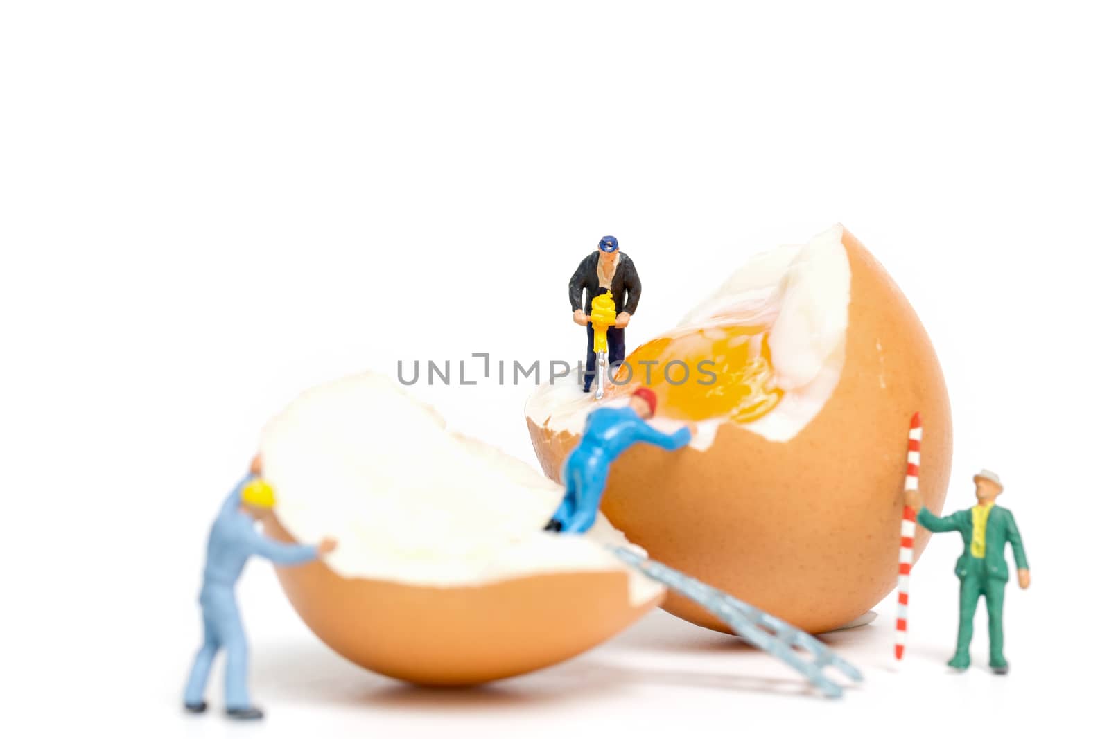 Miniature people work at Easter-eggs for Easter day on white background
