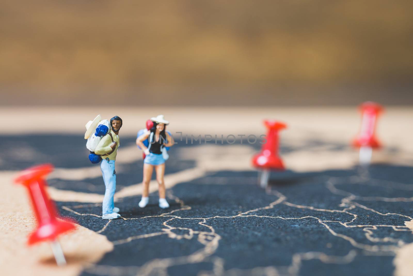 Miniature people backpacker walking on world map, Tourism and travel concept