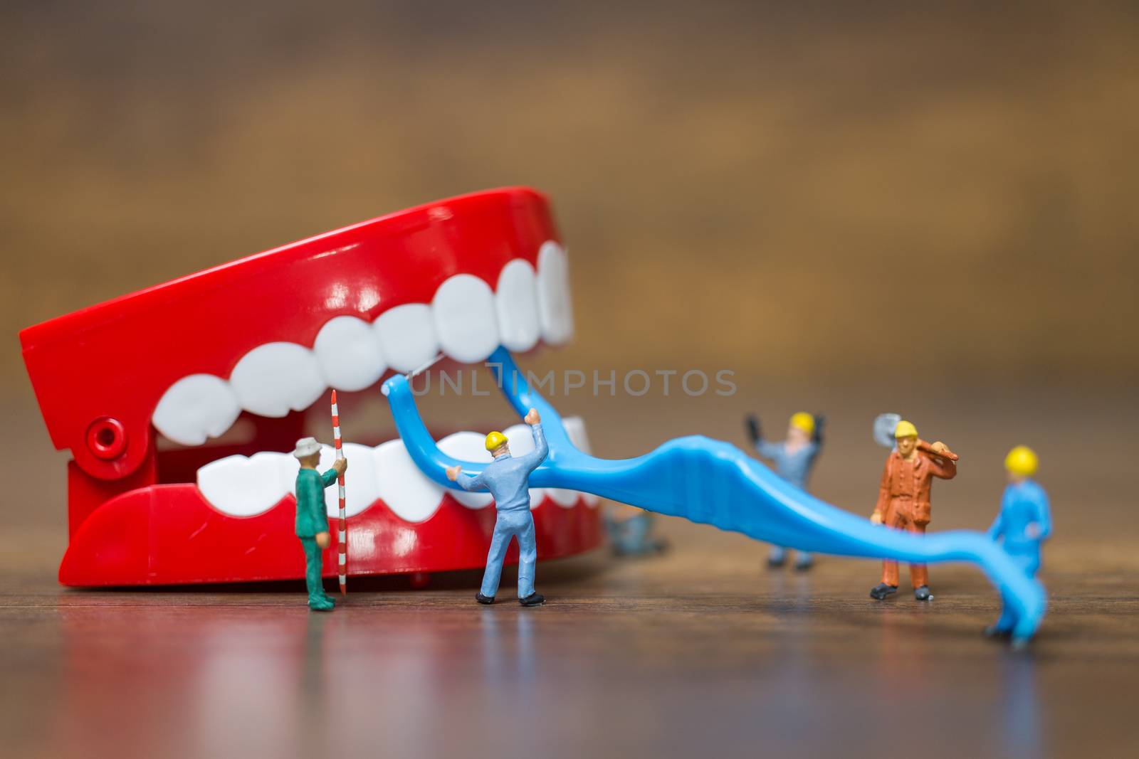 Miniature people : Worker team repairing a tooth ,Healthcare and medical concept