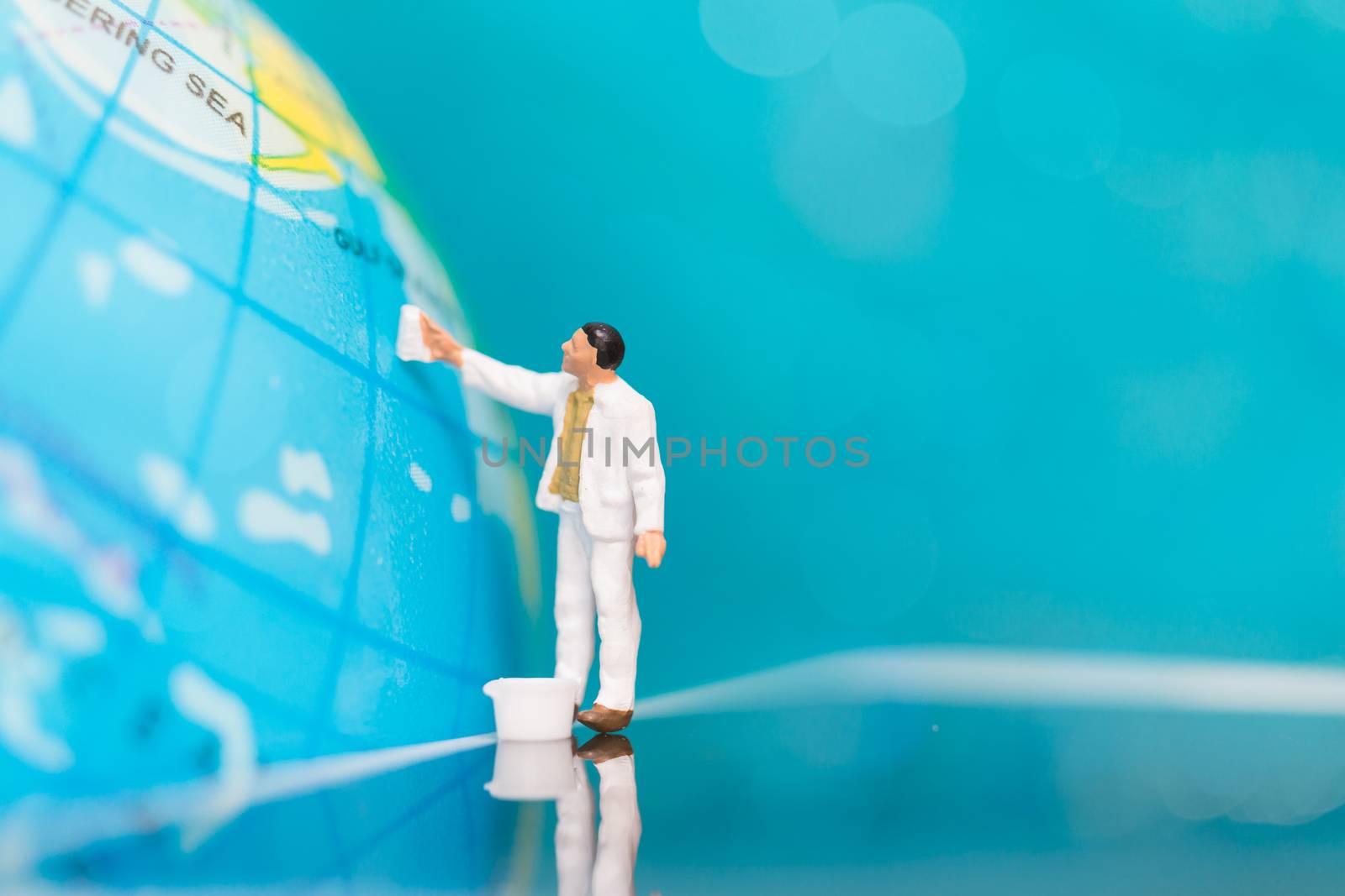 Miniature people : Painters painting on The globe  background , Earth day concept