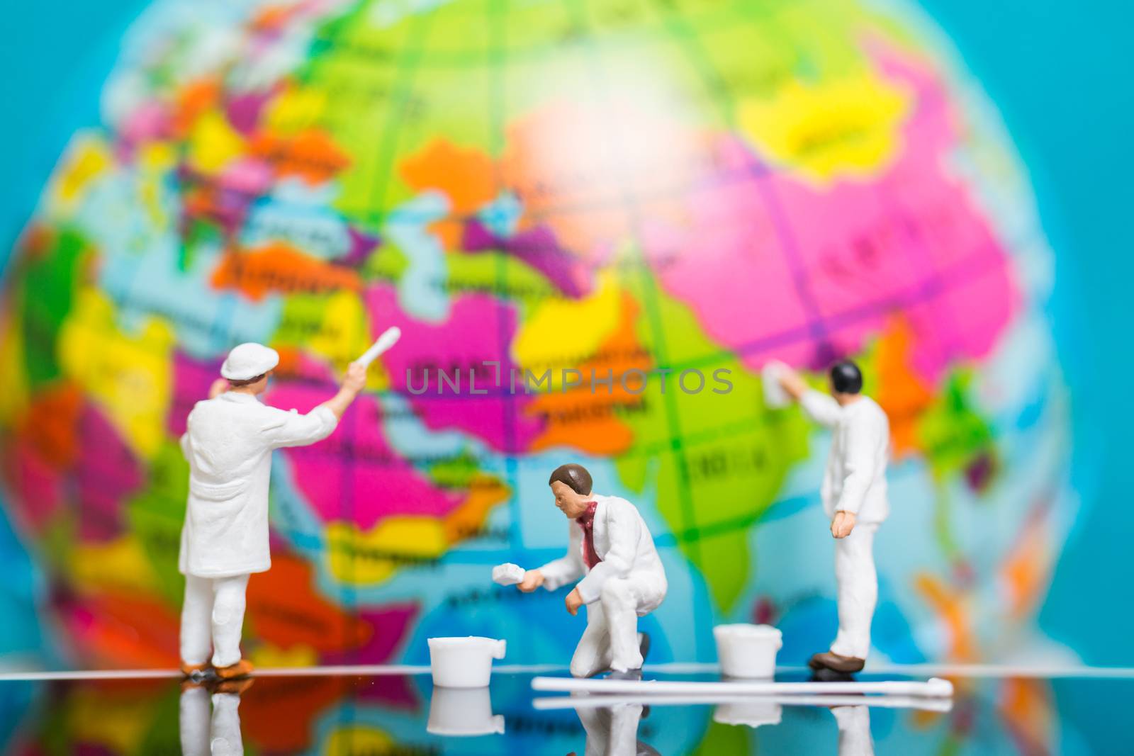 Miniature people : Painters painting on The globe  background , Earth day concept