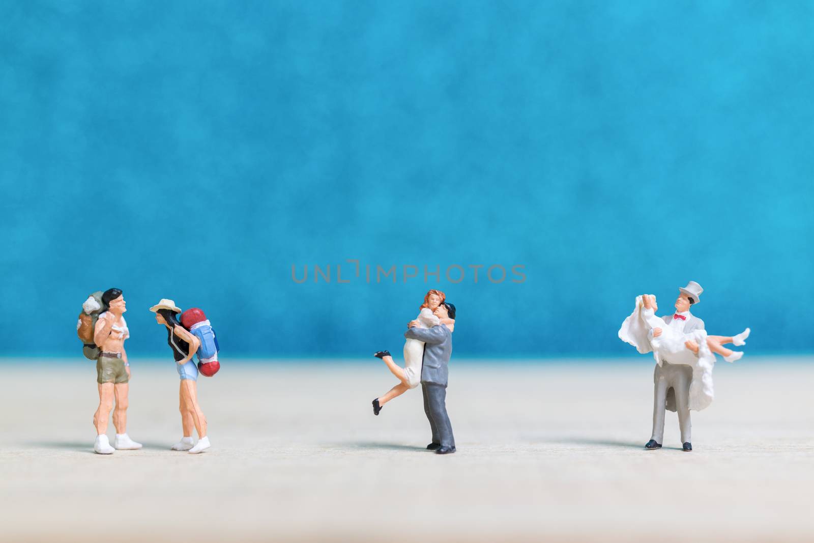 Miniature people : Bride and groom , Couple  on blue background.