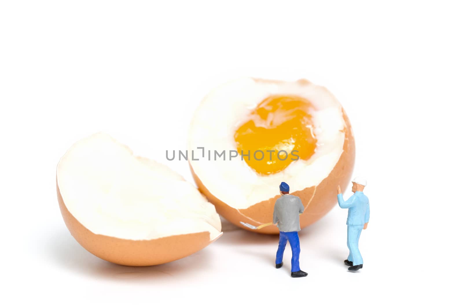 Miniature people work at Easter-eggs for Easter day on white background