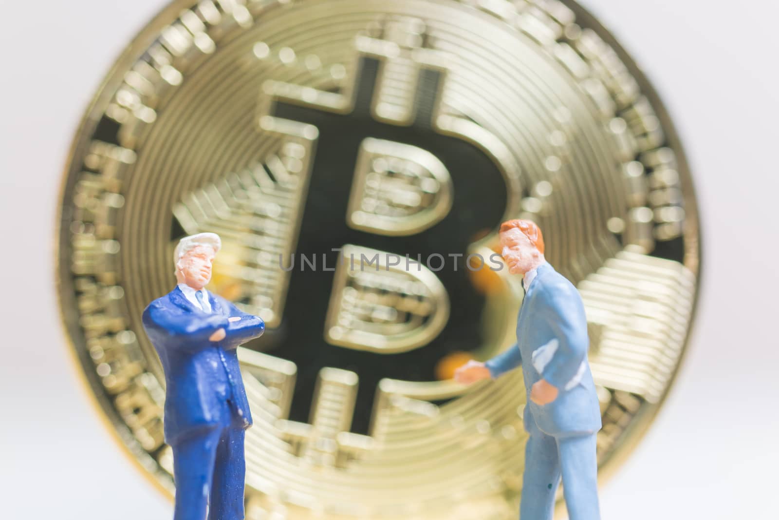 Miniature people: Businessman stand with Bitcoin currency in the form of digital (Cryptocurrency)  , Business concept.