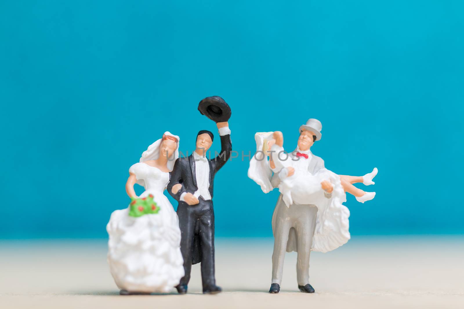 Miniature people : Bride and groom , Couple  on blue background.
