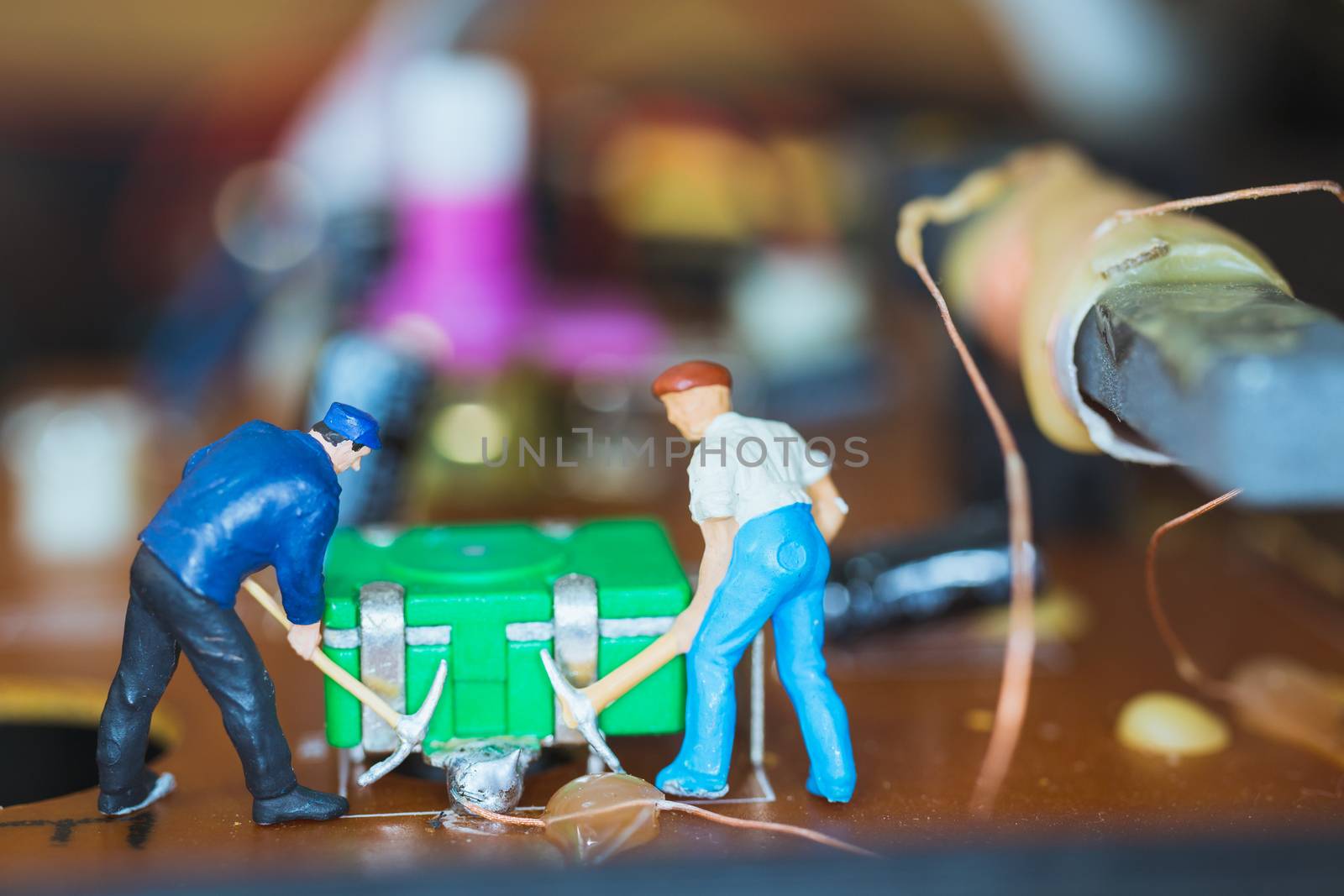 Miniature people : Worker team repairing Electronic Circuits. , Construction workers concept