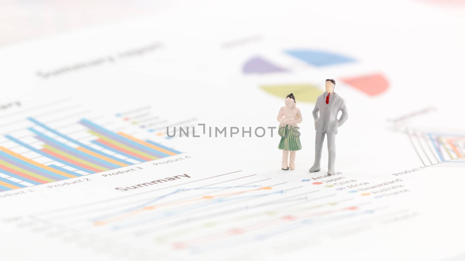 Miniature figures businessman standing on a graph chart