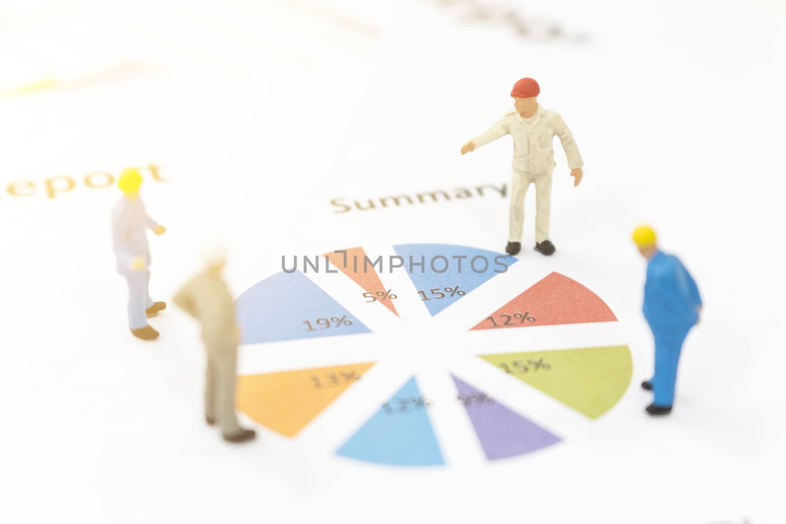 Miniature figures businessman standing on a graph chart  