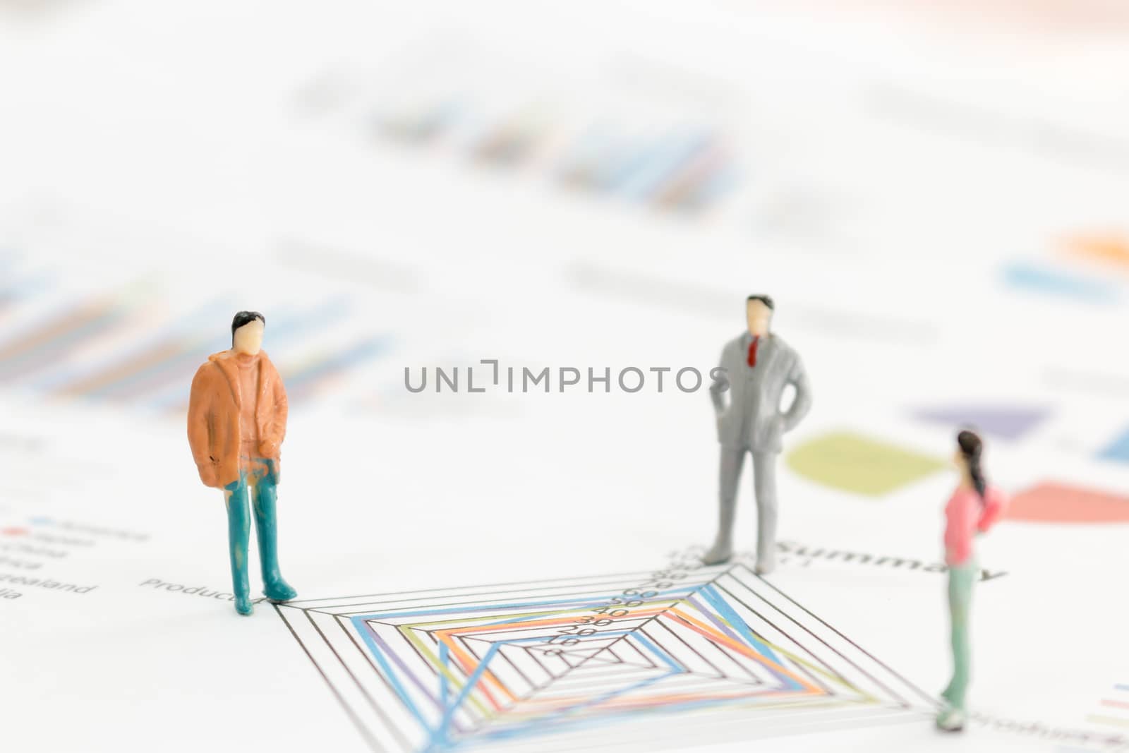 Miniature figures businessman standing on a graph chart