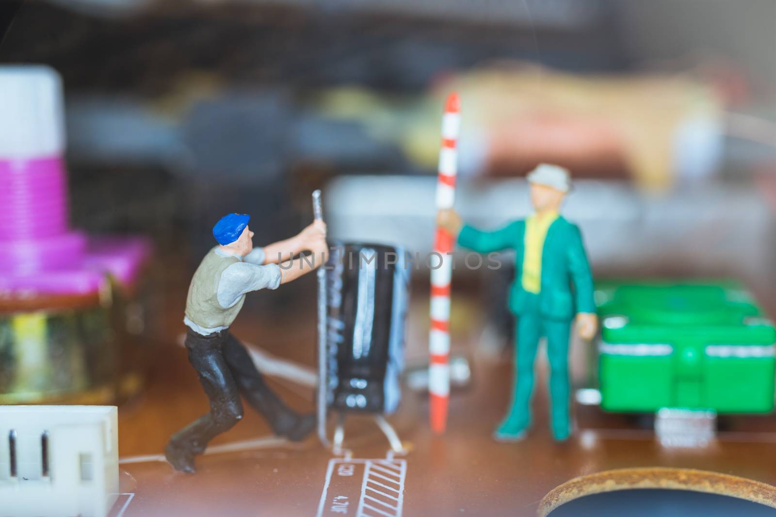 Miniature people : Worker team repairing Electronic Circuits. , Construction workers concept