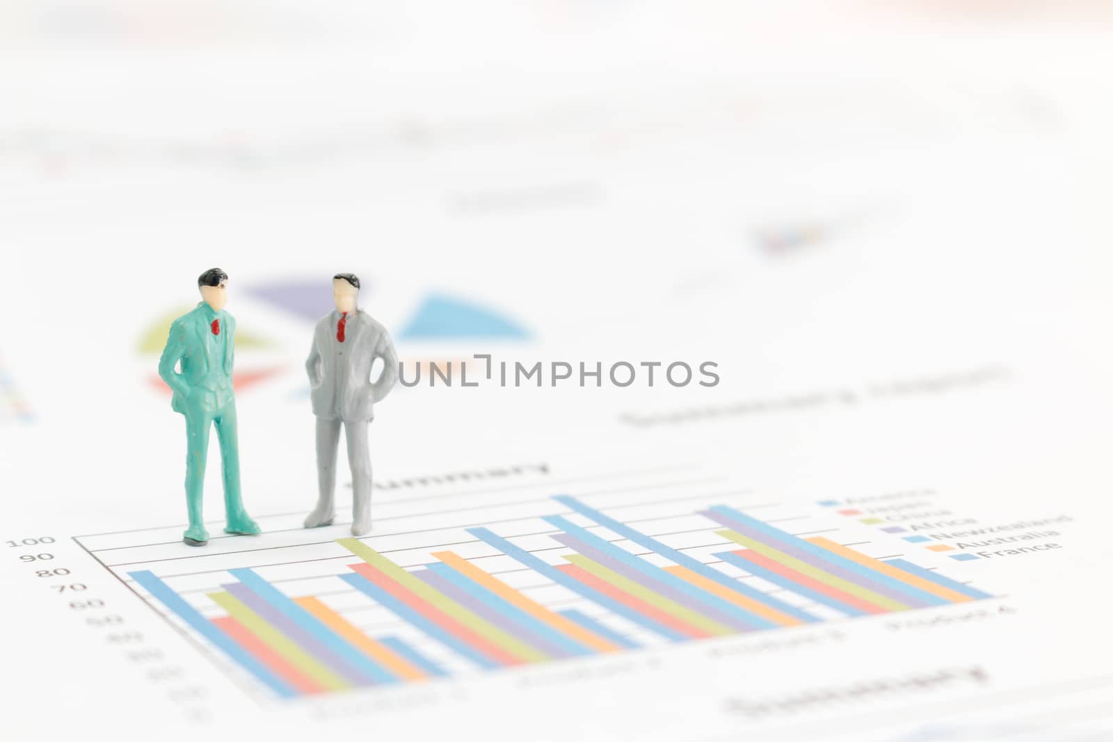 Miniature figures businessman standing on a graph chart
