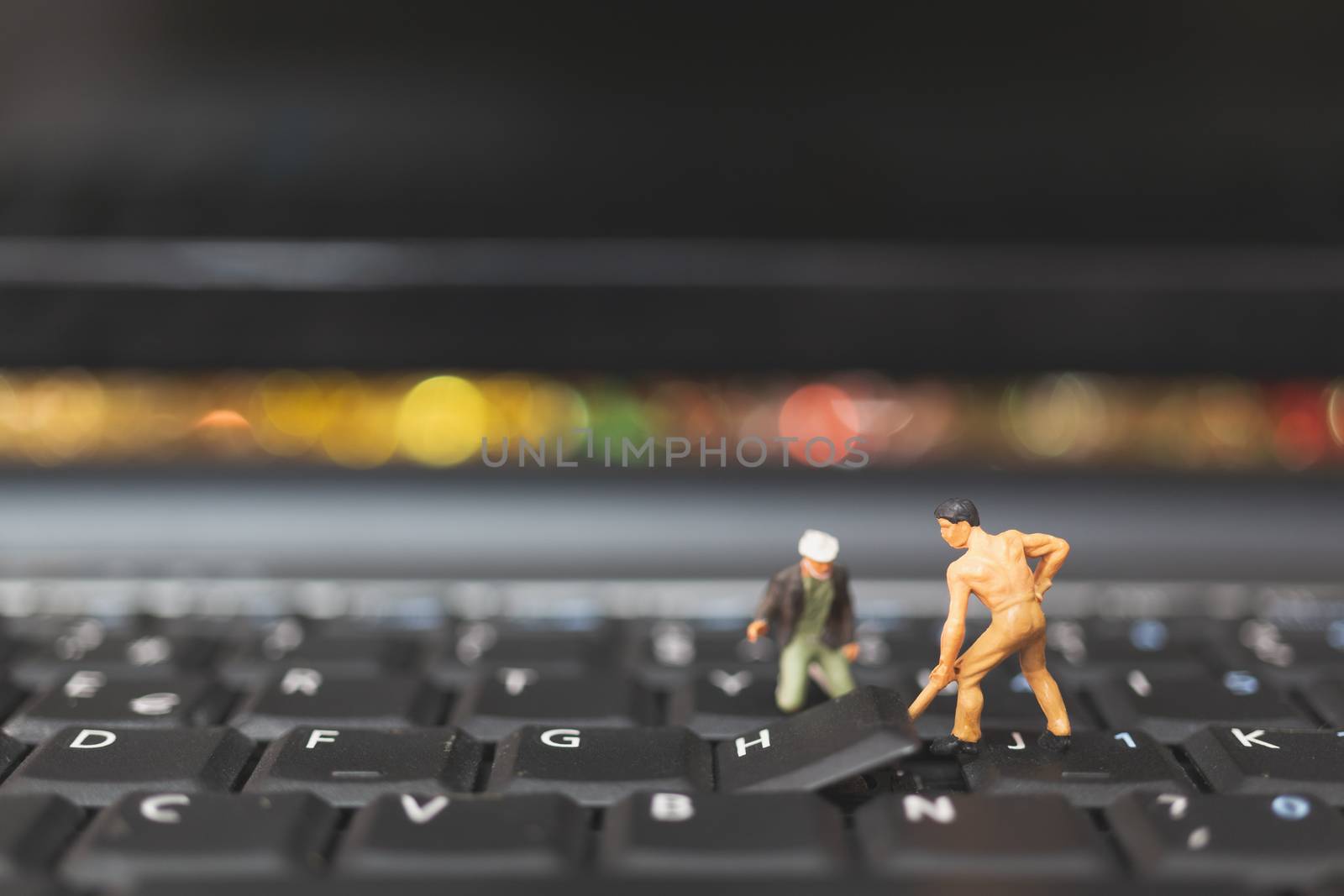 Miniature people : Worker team of engineers repairing keyboard computer laptop. Computer repair concept.