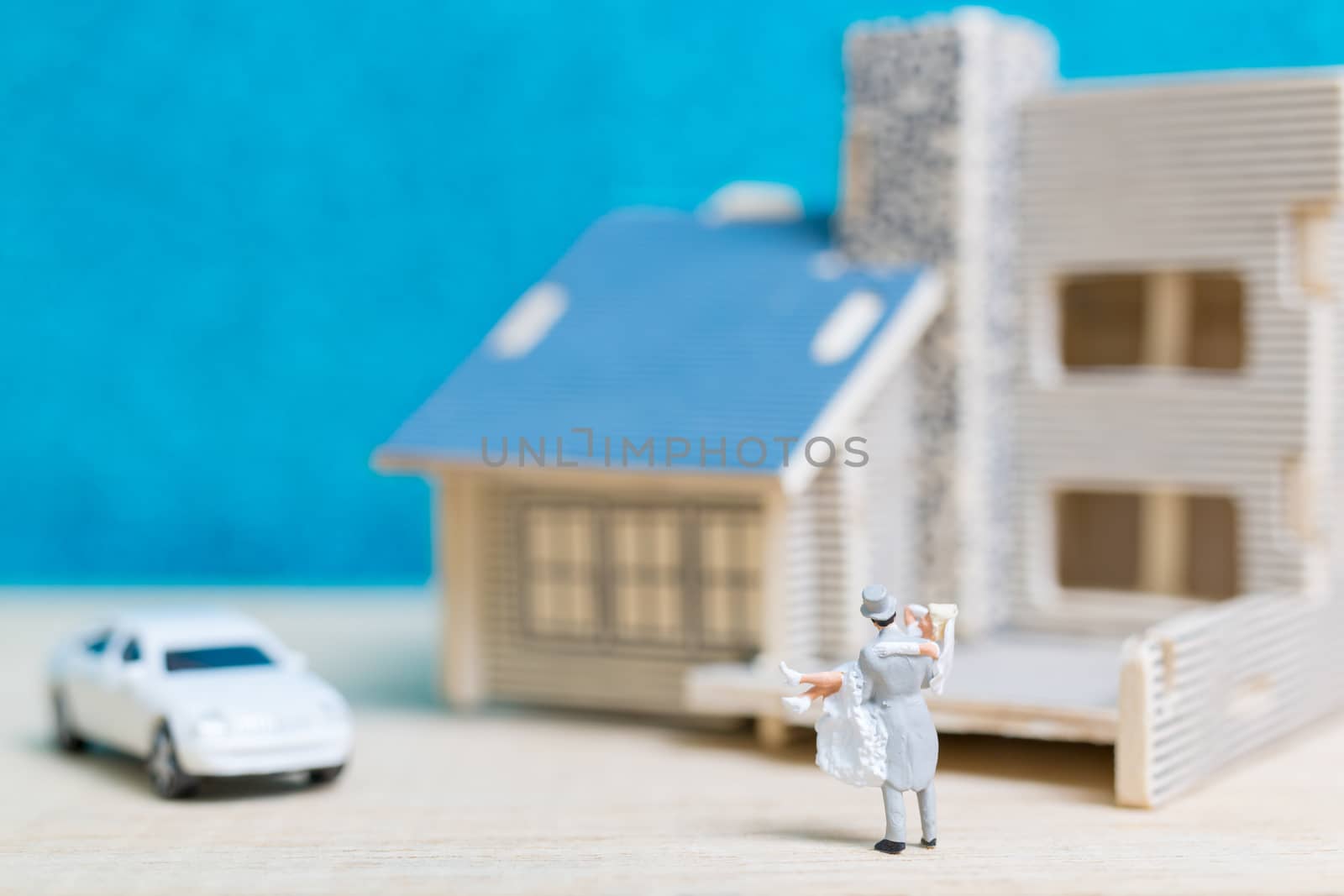 Miniature people : Bride and groom , Couple  on blue background.