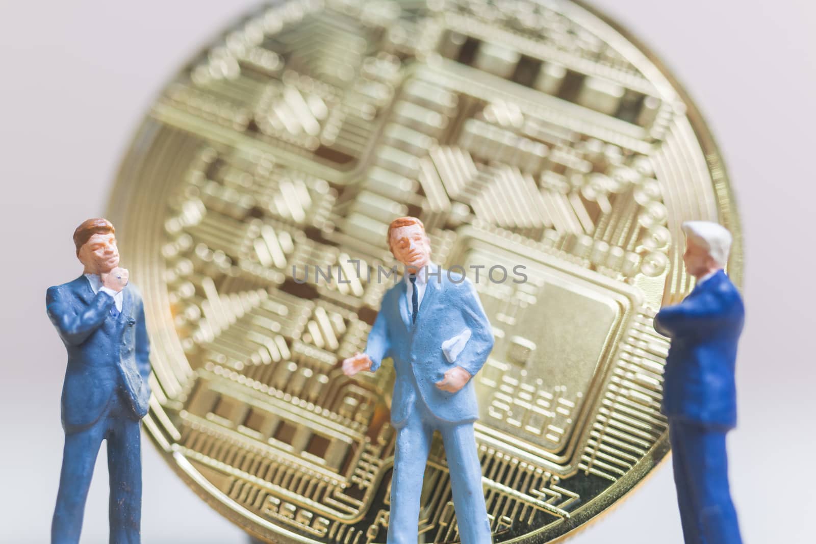 Miniature people: Businessman stand with Bitcoin currency in the form of digital (Cryptocurrency)  , Business concept.