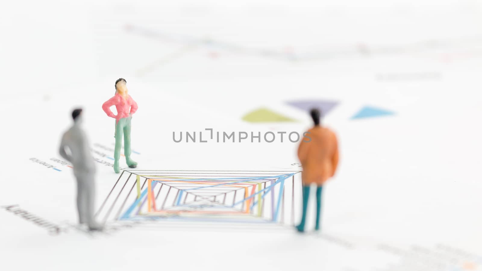 Miniature figures businessman standing on a graph chart