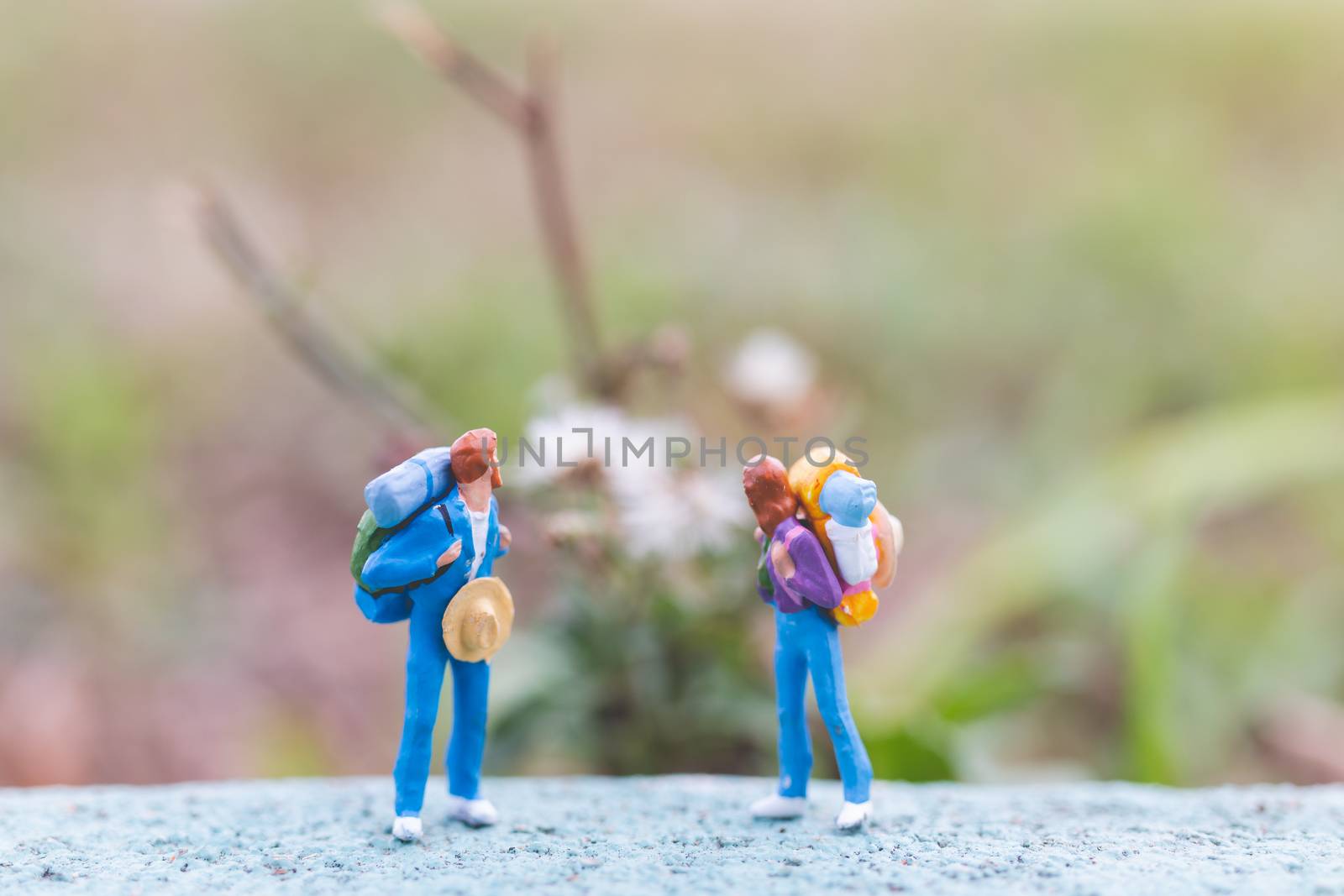 Miniature people :  Traveler with backpack standing on The road . Travel and trekking Concept