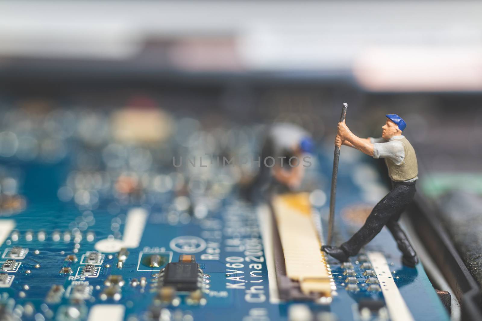 Miniature people : Worker team of engineers repairing keyboard computer laptop. Computer repair concept.