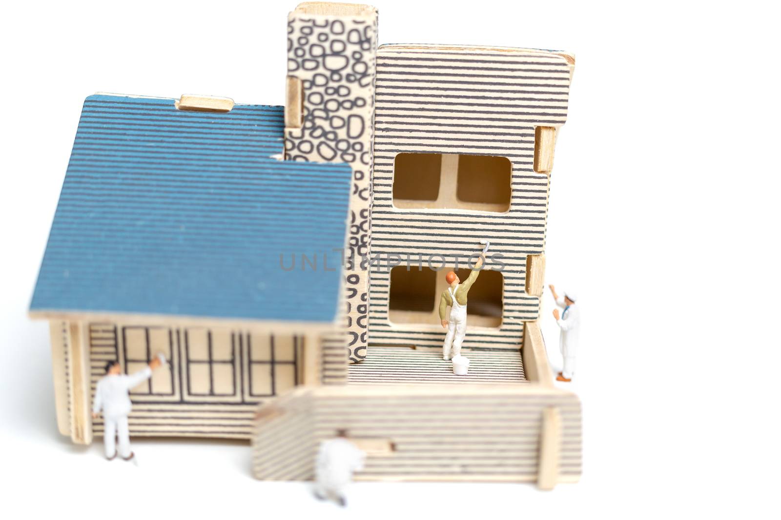 Miniature people : Paintbrush painting wooden house on white background