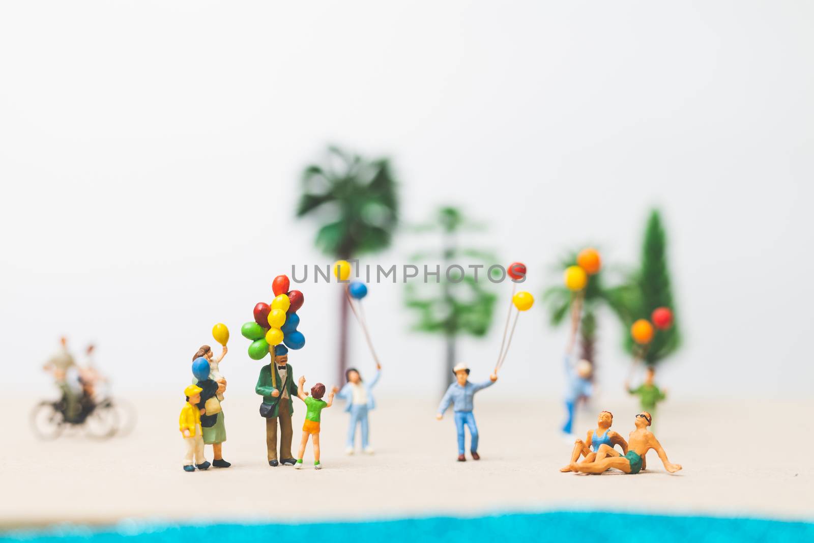Miniature people : happy family enjoy summer vacation on the beach