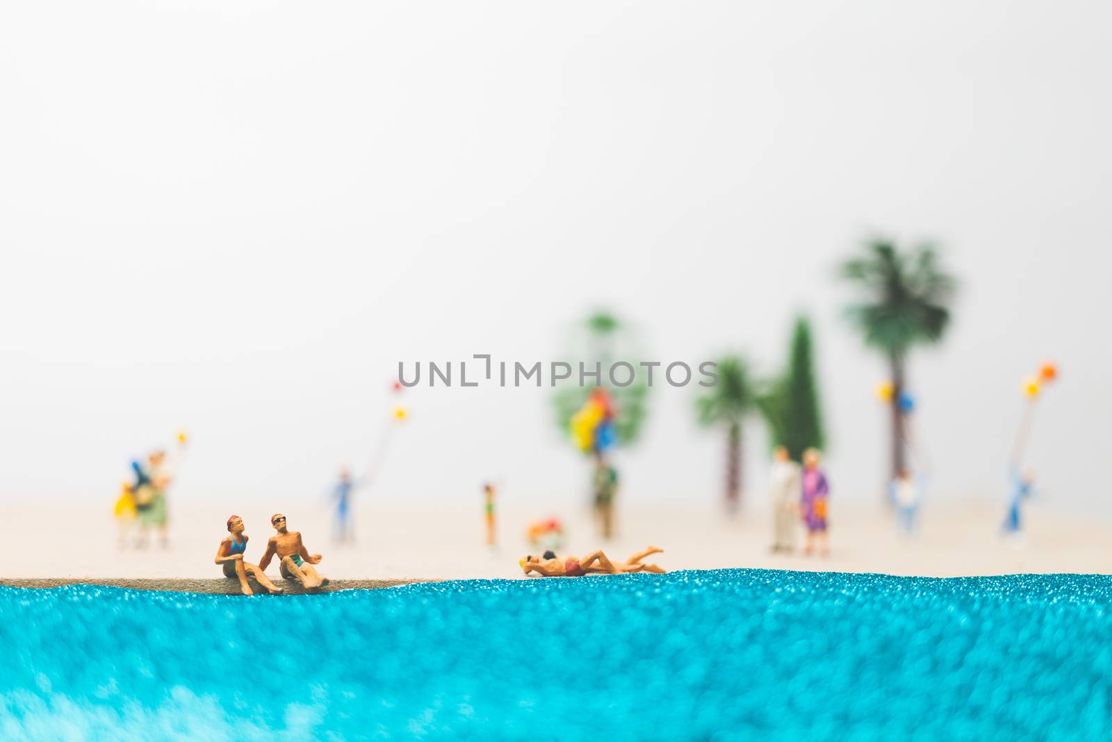 Miniature people : happy family enjoy summer vacation on the beach