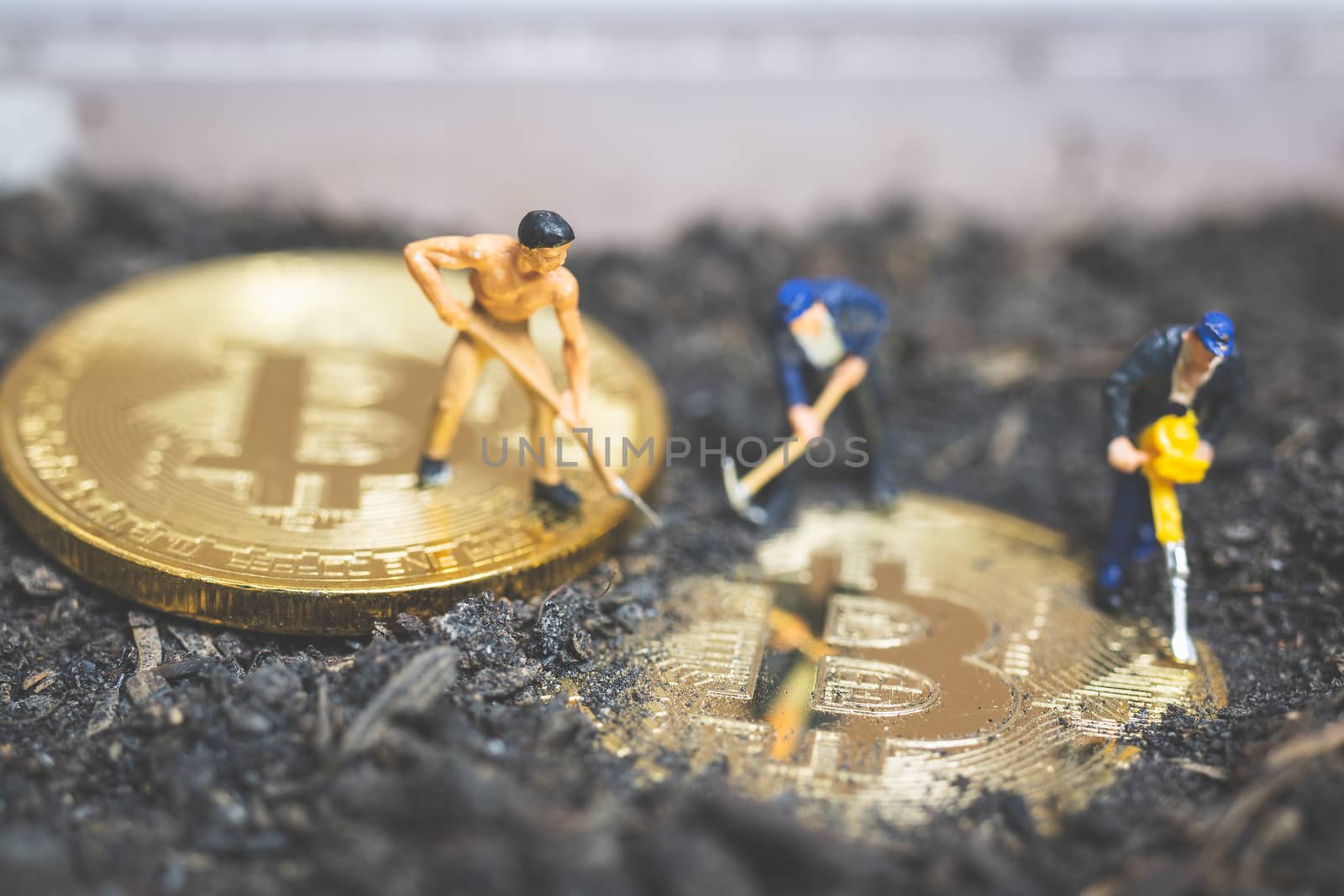 Miniature people : Worker team digging ground to uncover big shiny bitcoin ,  Successful work concept