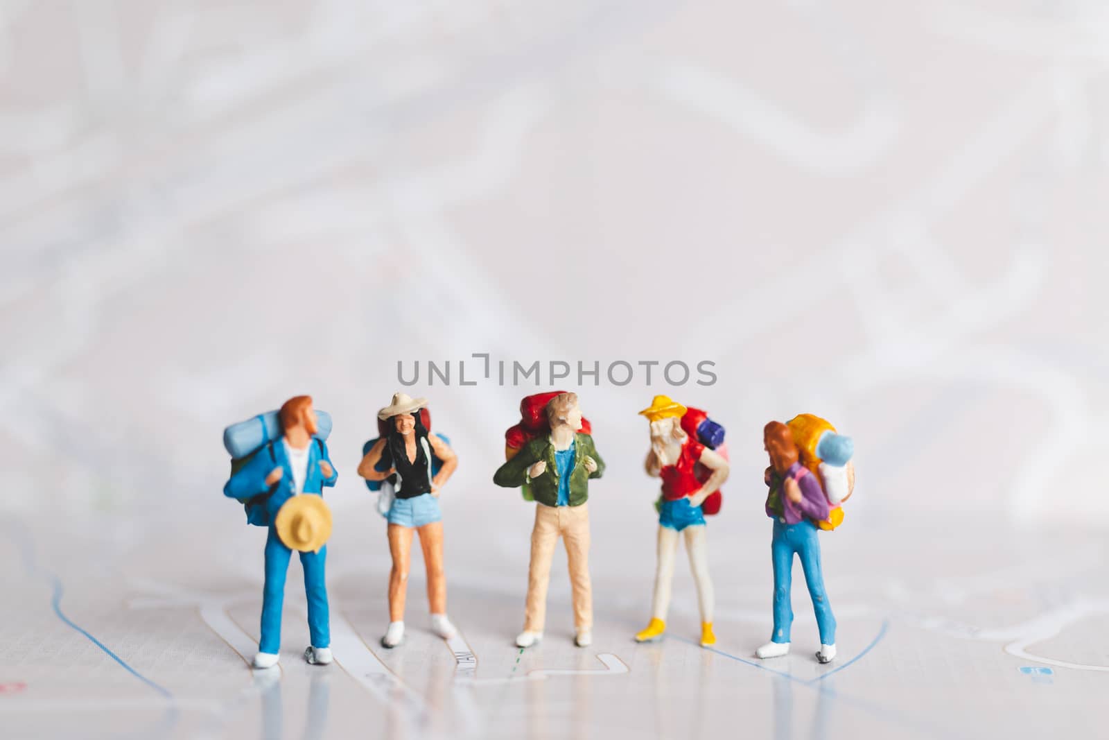 Miniature people : Traveler with backpack walking on map , Travel and Adventure concepts.
