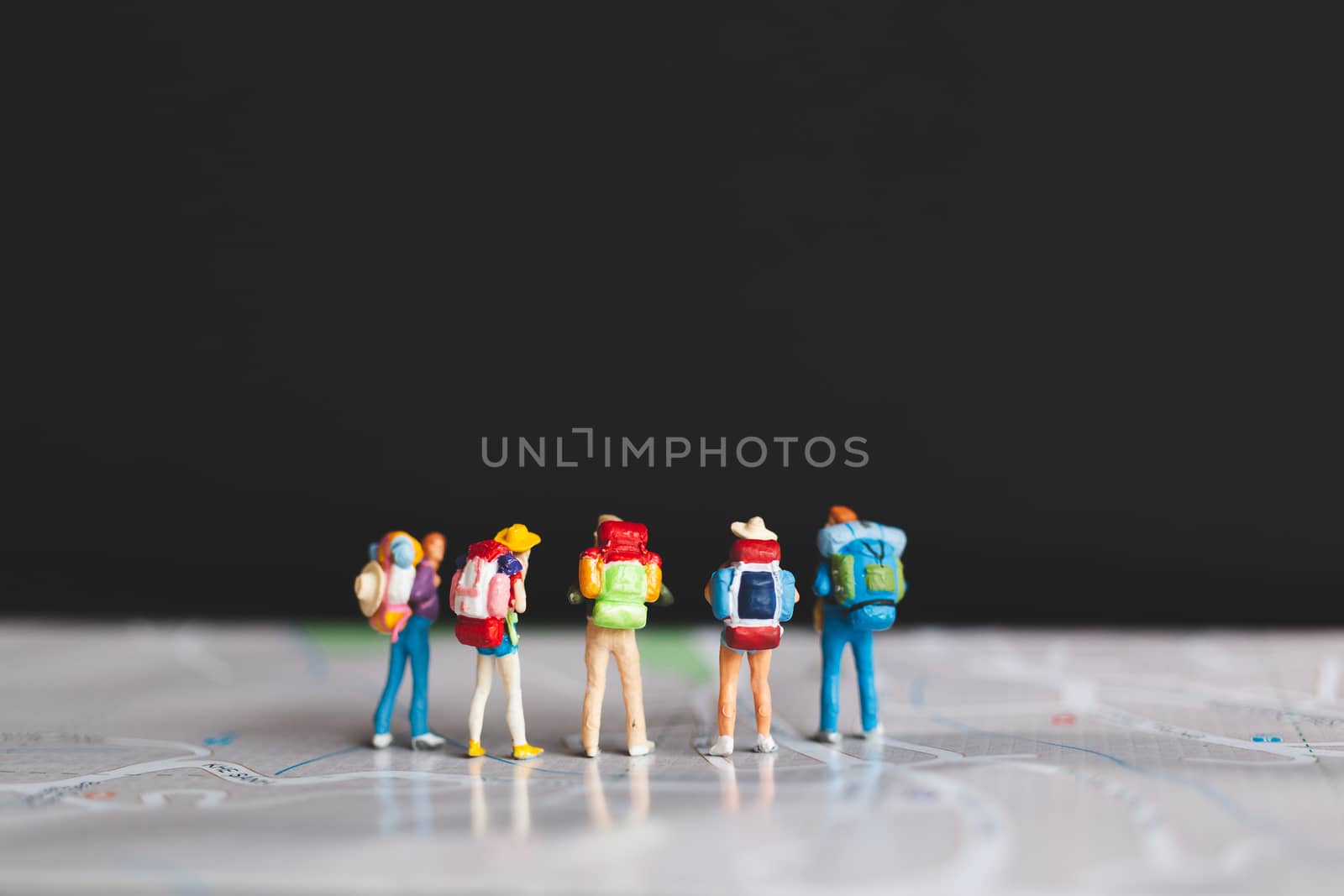 Miniature people : Traveler with backpack walking on map , Travel and Adventure concepts.