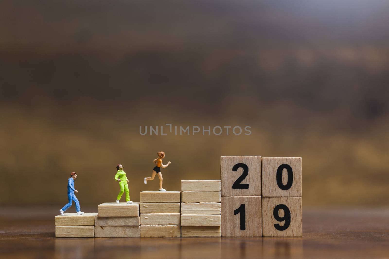 Miniature people  Running on wooden block number 2019 , Healthy lifestyle and sport concepts.