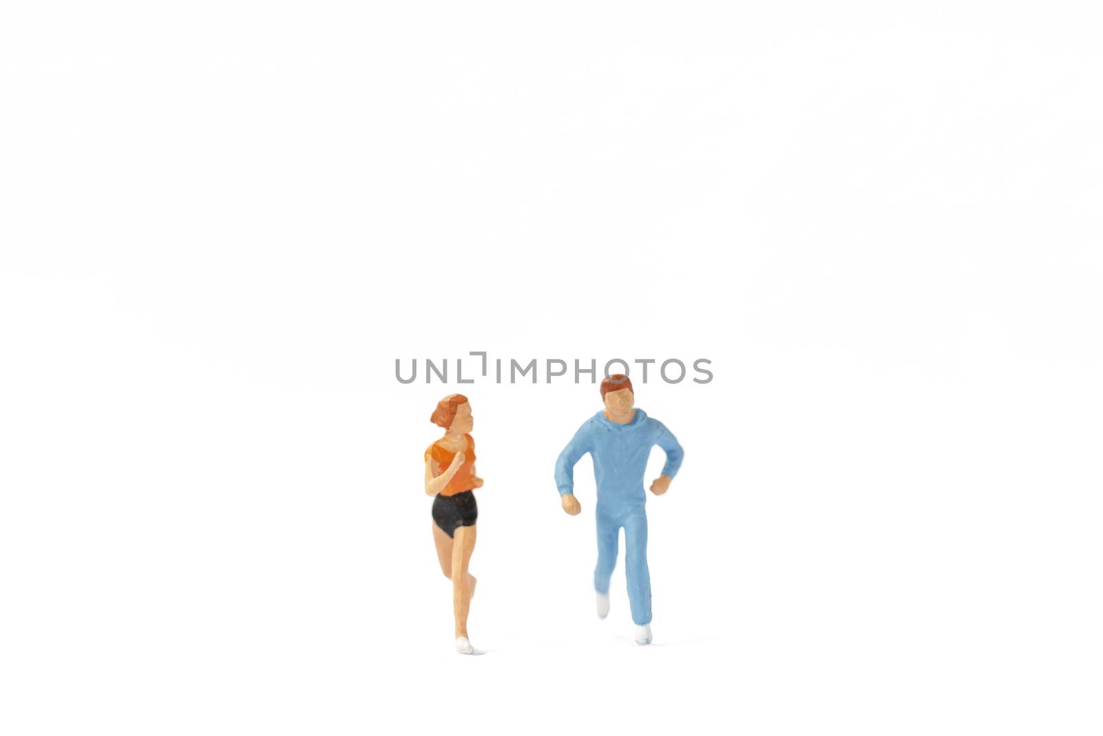 Miniature people running on white background , Healthy lifestyle and sport concepts. by sirichaiyaymicro