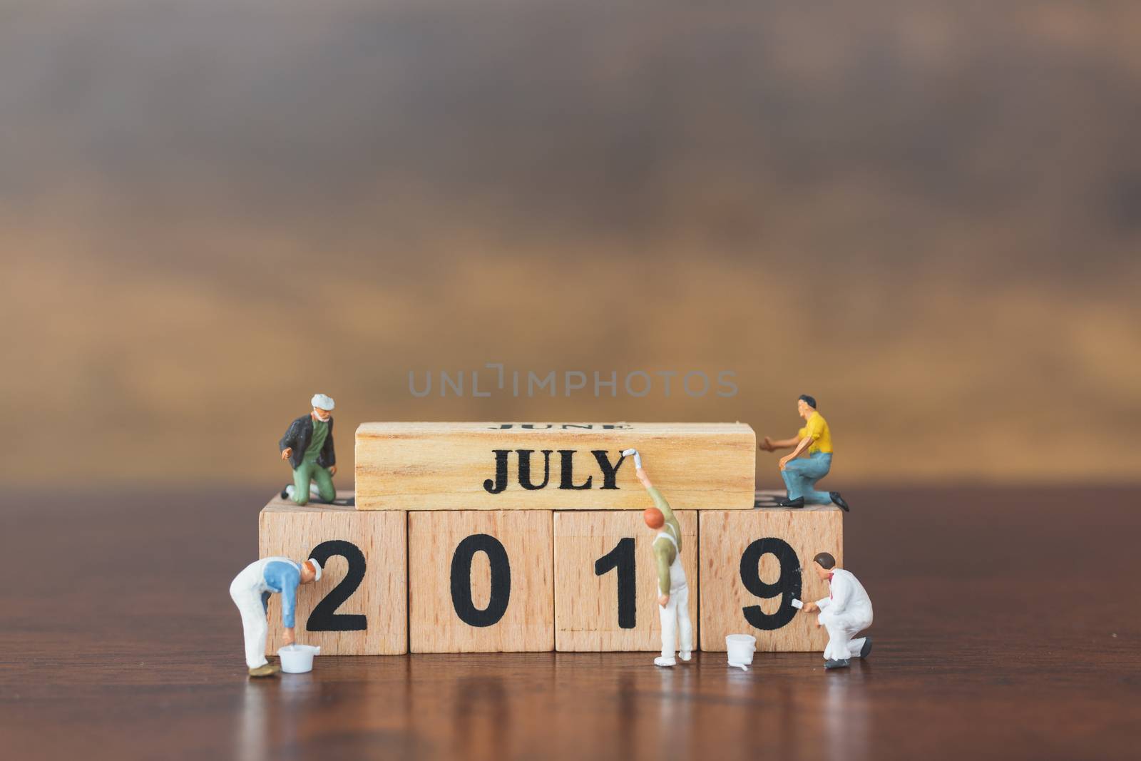 Miniature worker team painting  on wooden block , Happy new year 2019 concept