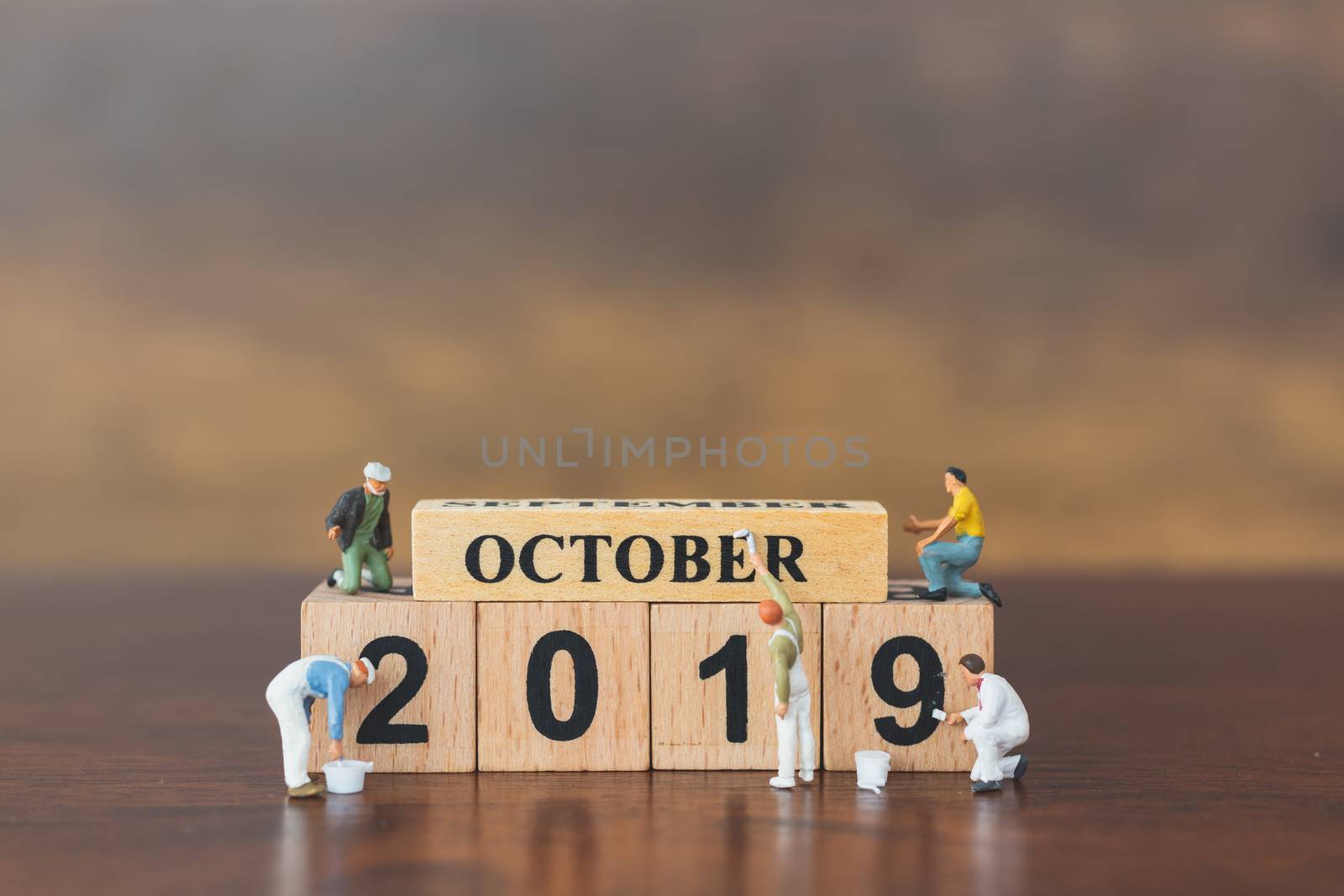 Miniature worker team painting  on wooden block , Happy new year 2019 concept