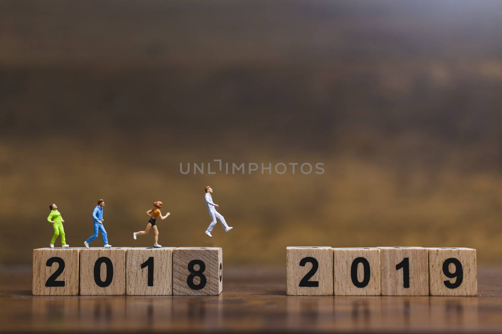 Miniature people  Running on wooden block number 2019  by sirichaiyaymicro