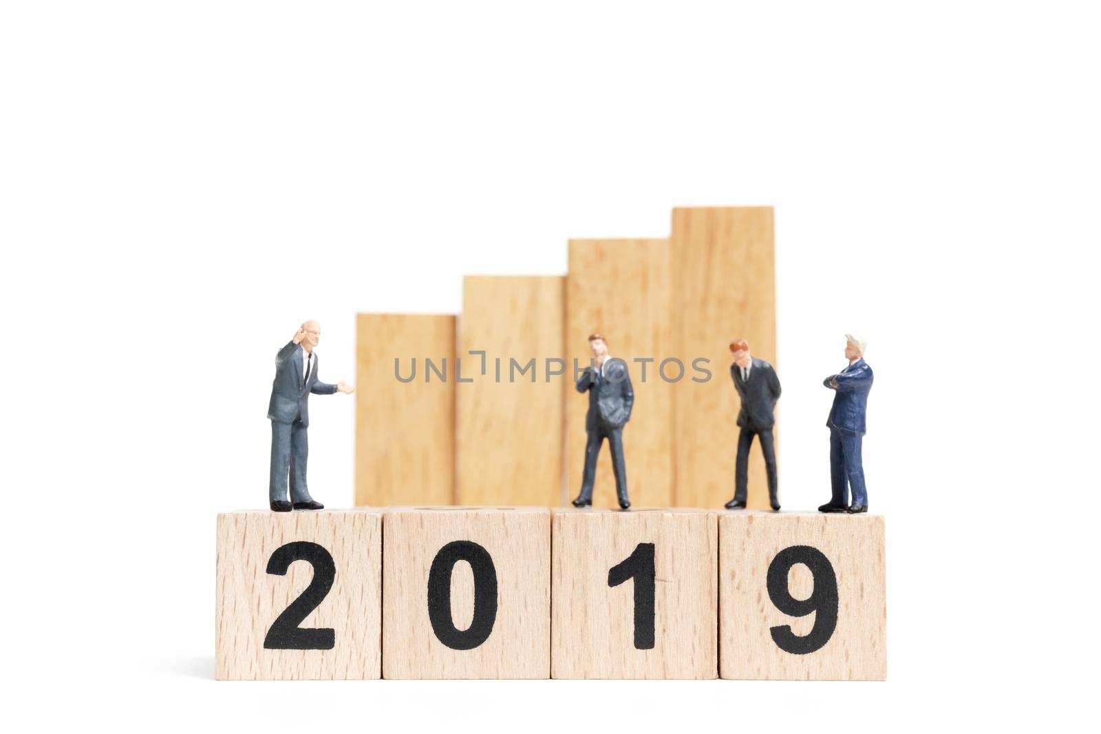 Miniature people : businessman  standing and thinking on wooden block number 2019. on white background