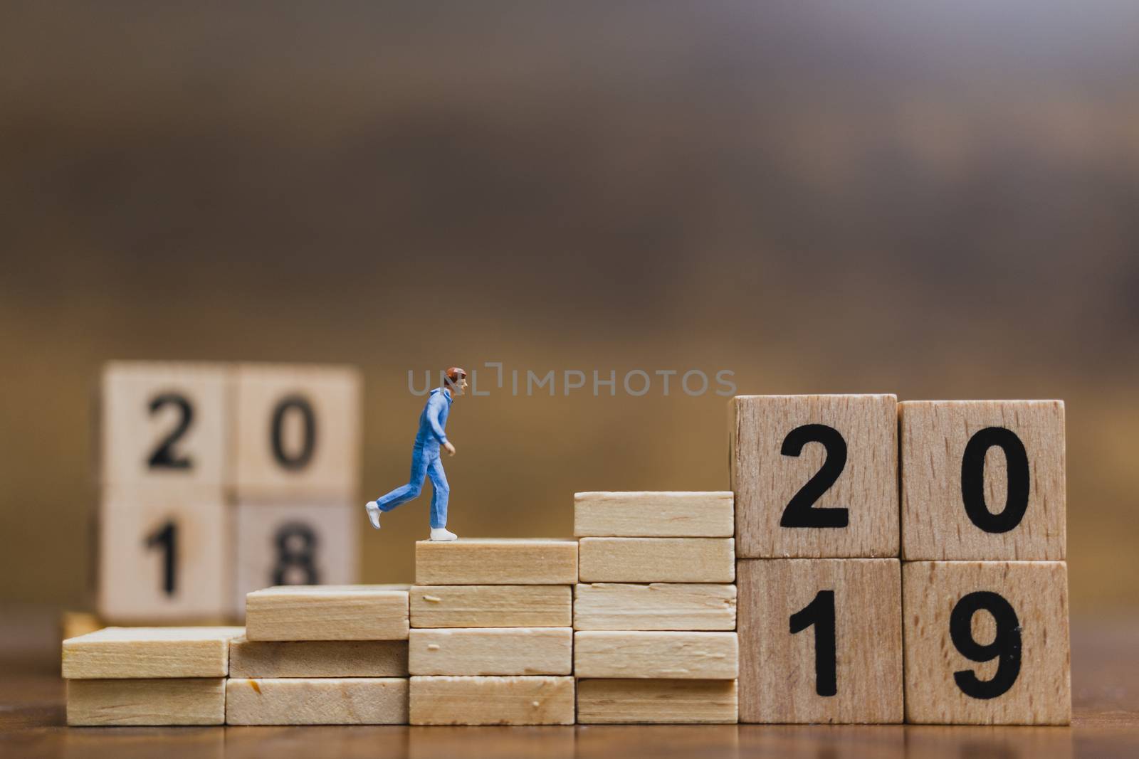 Miniature people  Running on wooden block number 2019  by sirichaiyaymicro