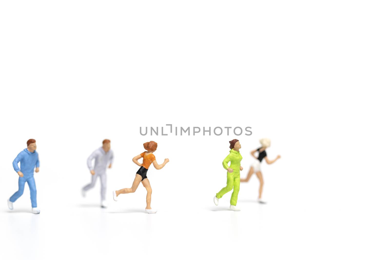 Miniature people running on white background , Healthy lifestyle and sport concepts.