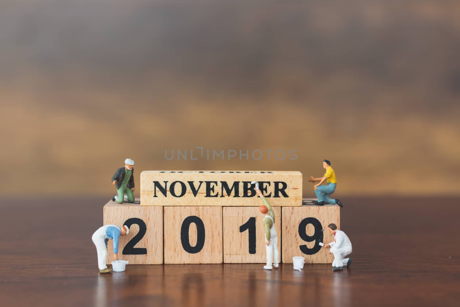 Miniature worker team painting  on wooden block , Happy new year 2019 concept