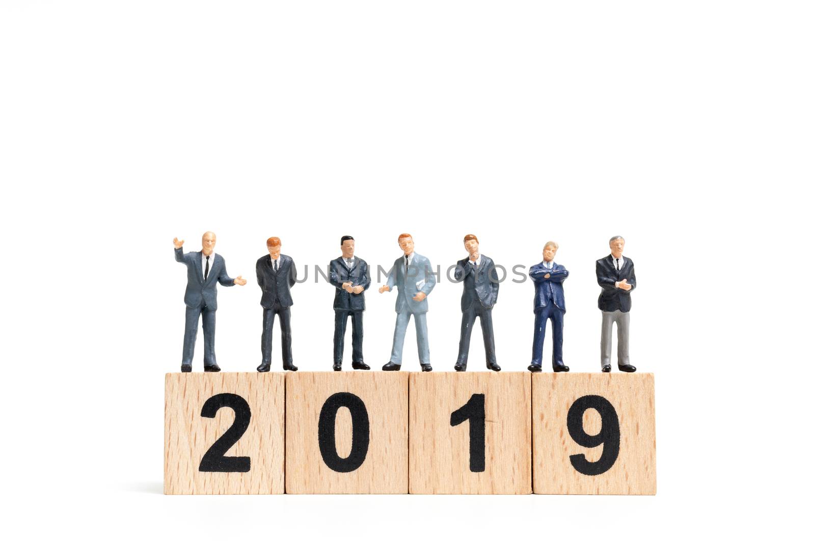 Miniature people : businessman  standing and thinking on wooden block number 2019. on white background