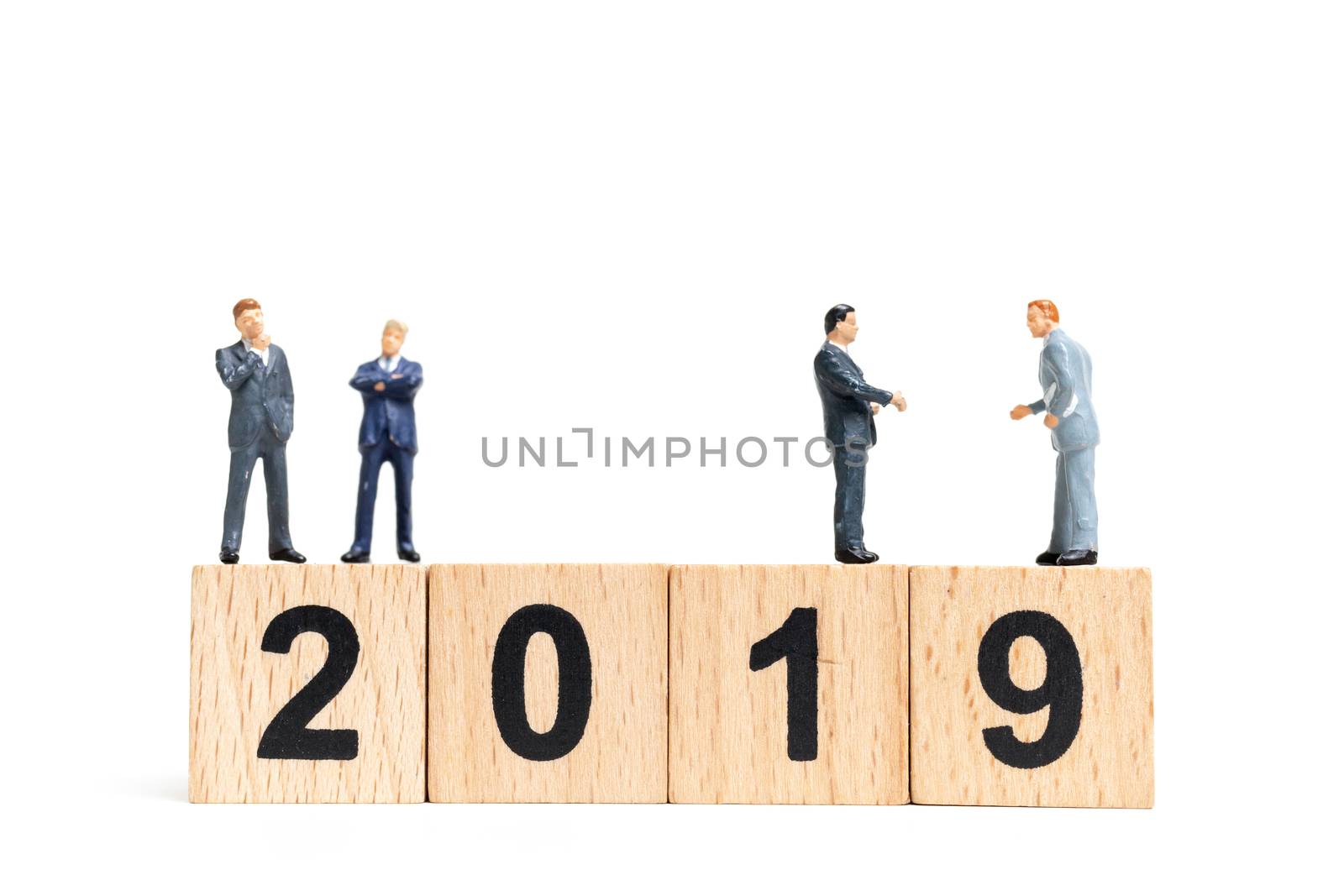 Miniature people : businessman  standing and thinking on wooden block number 2019. on white background