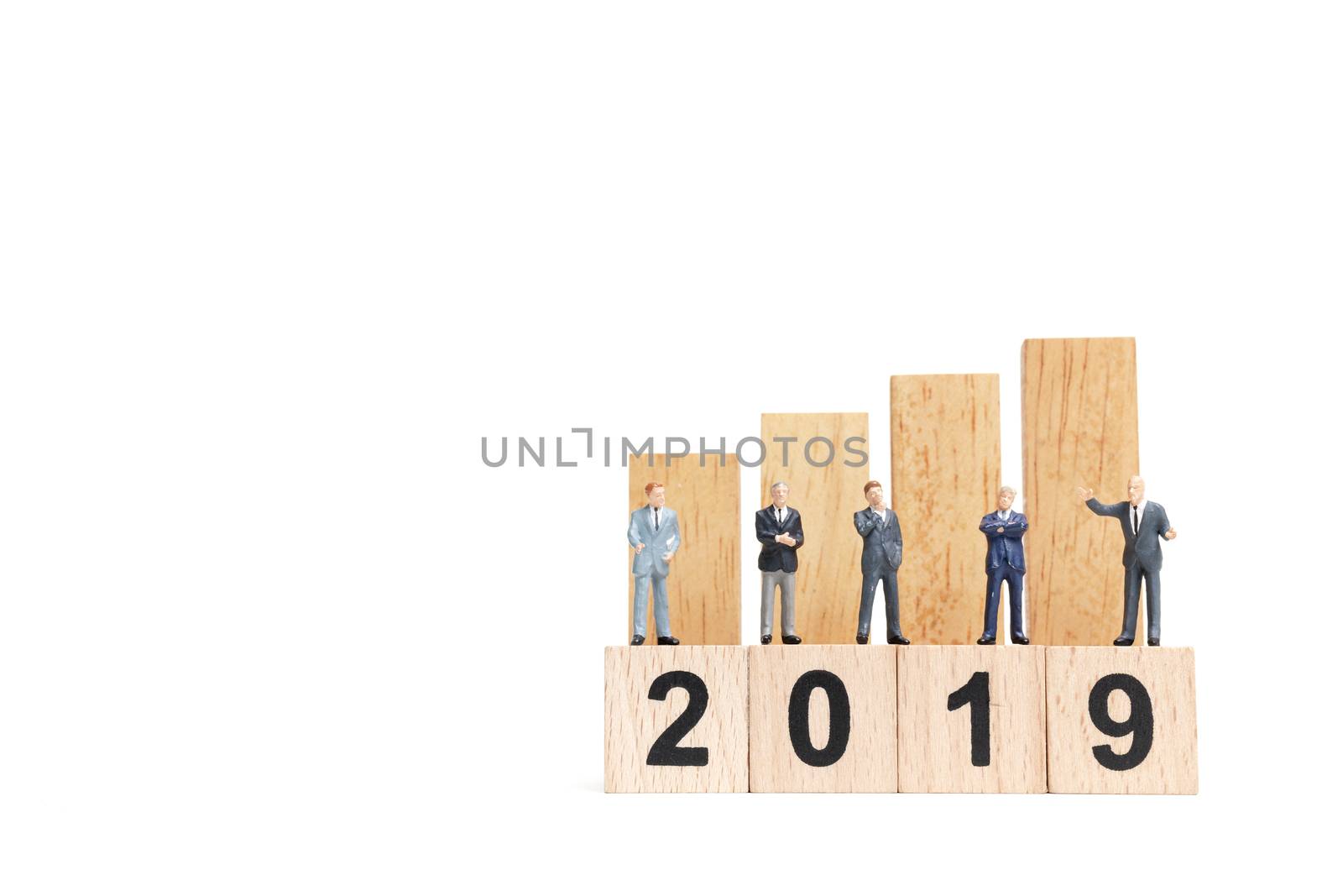 Miniature people : businessman  standing and thinking on wooden block number 2019. on white background